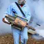Fumigation technician applying smoke treatment for pest control in {city}, {state}